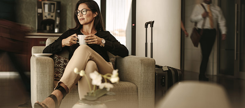Woman lounging with luggage at Airport